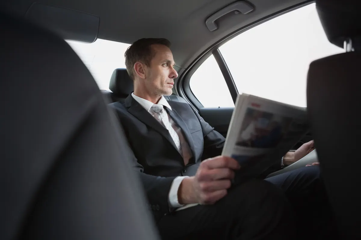 Passenger relaxing in the back of a car